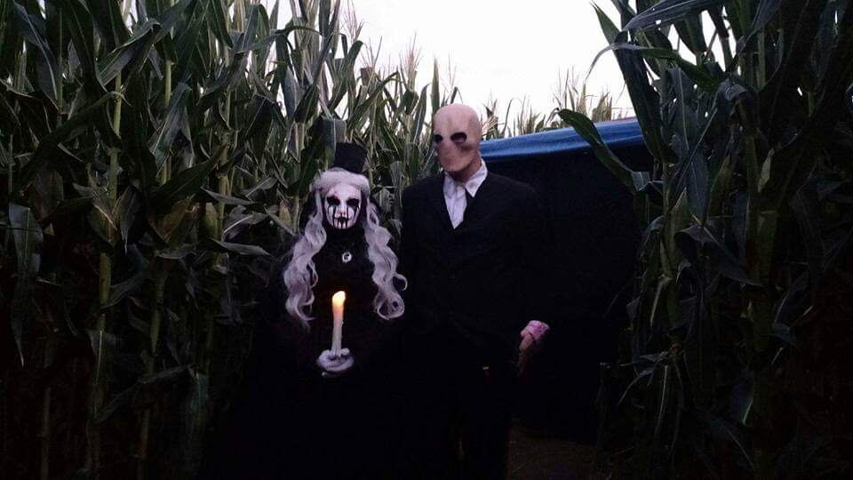 Costumed haunted maze actors in the corn