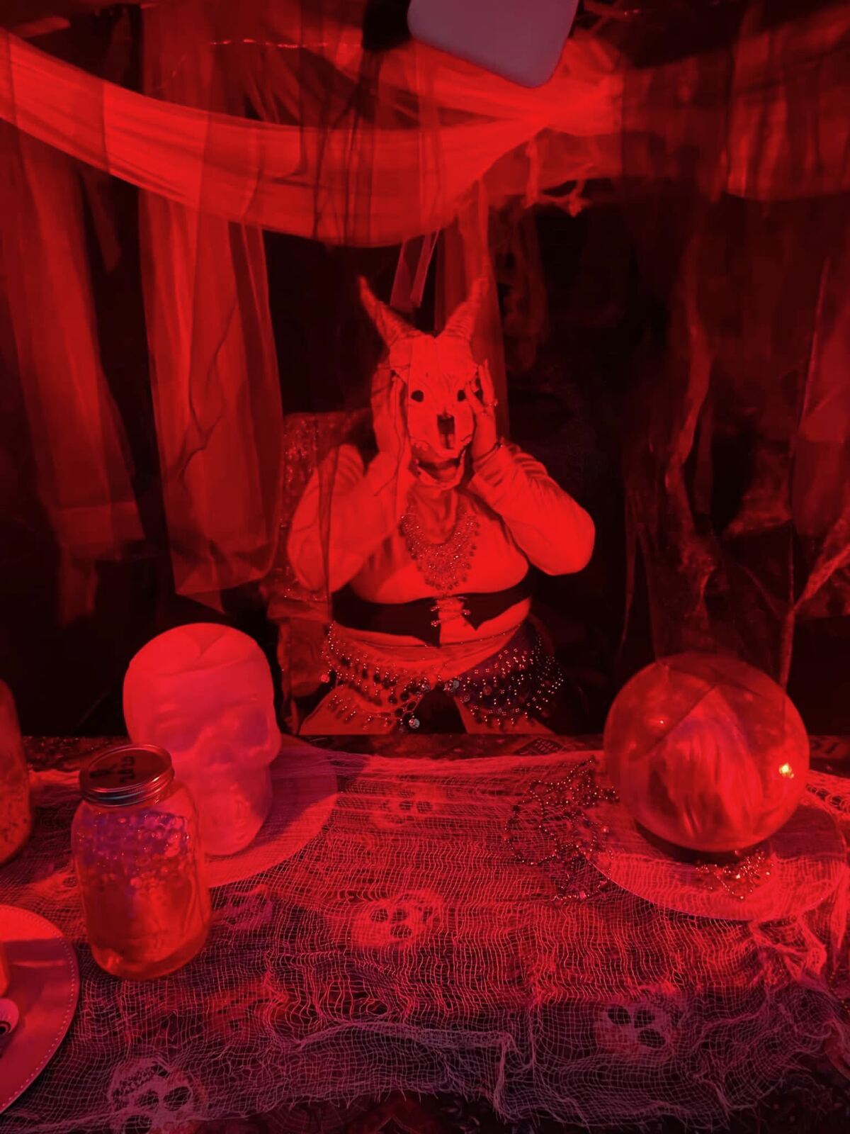 Costumed actor with animal skull mask