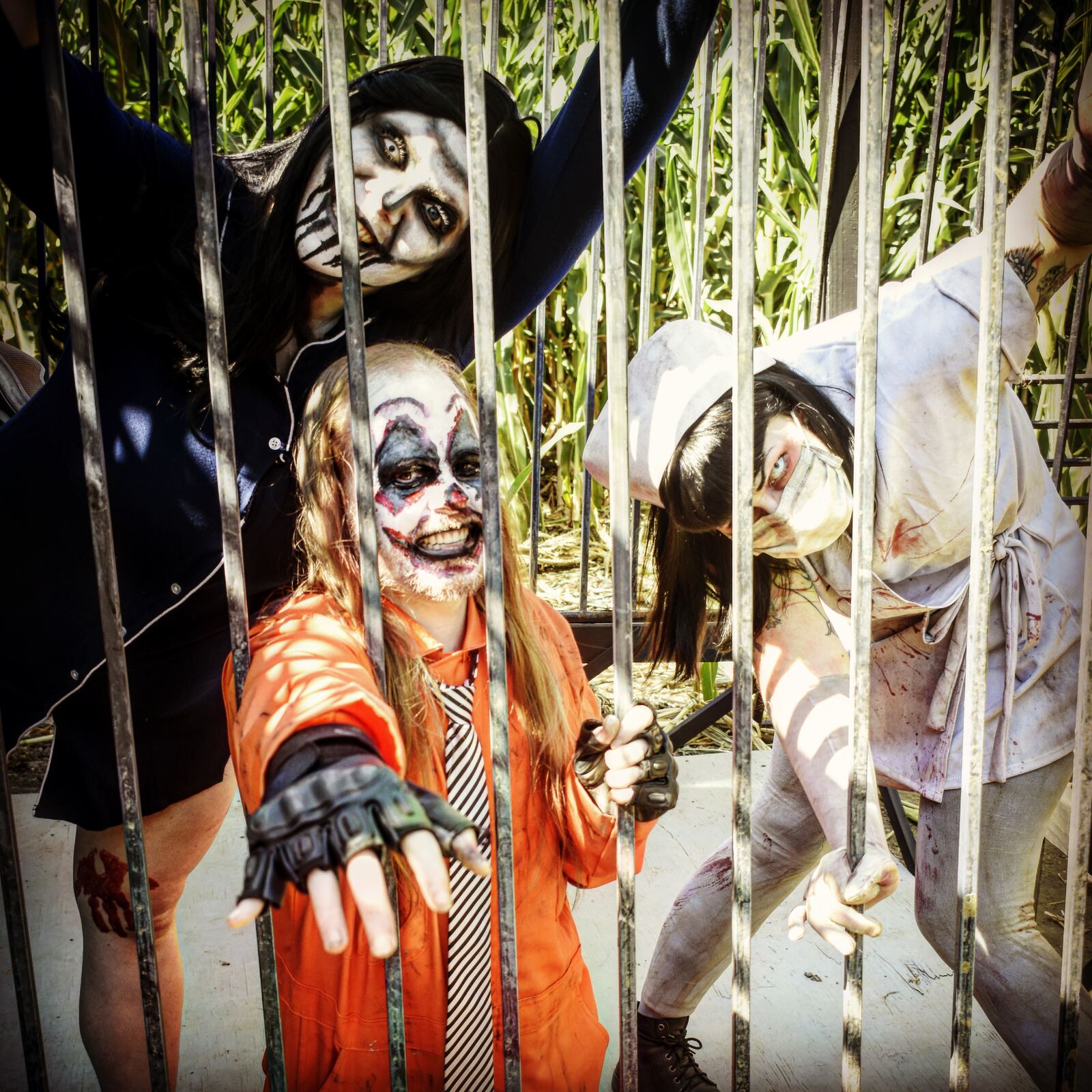 Costumed haunted maze actors behind bars