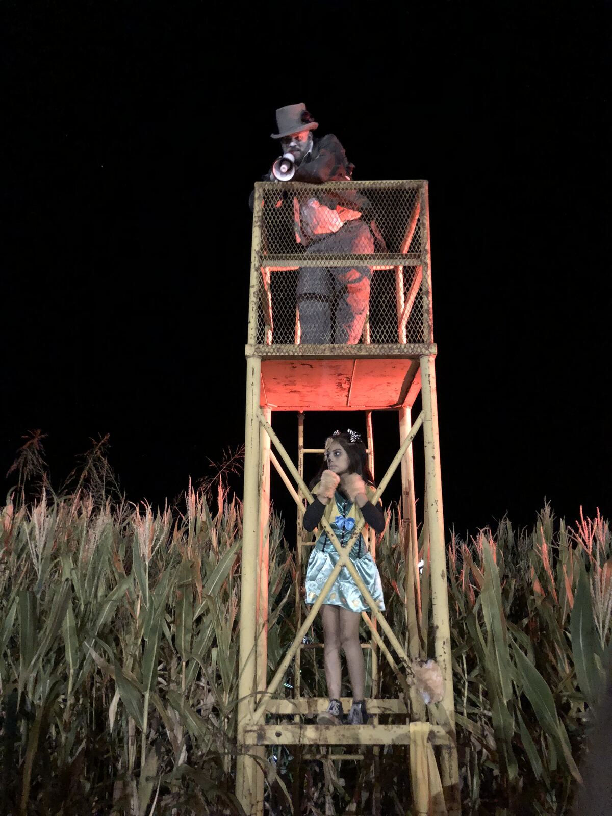 Costumed haunted maze actor on a watchtower
